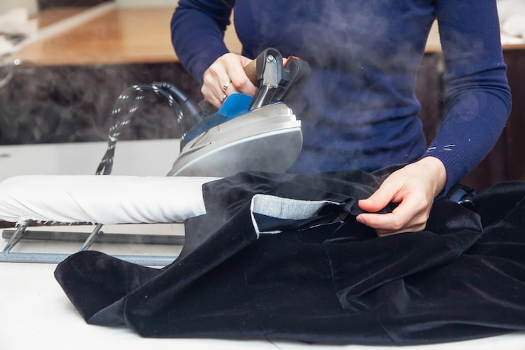 seamstress-steams-velvet-jacket-with-iron-her-atelier-authentic-lifestyle_158155-516